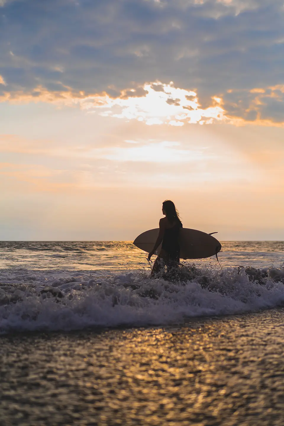 Surfer at sunset on Cocoa Beach